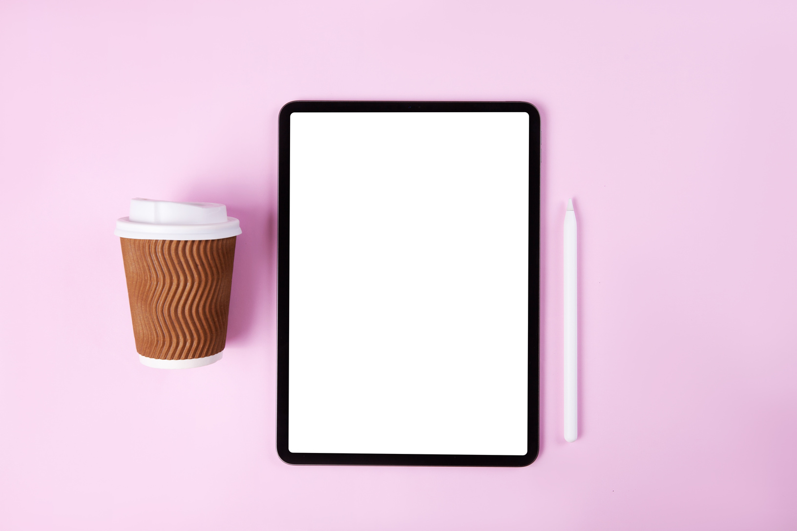 Tablet and Coffee Cup on Pink Background